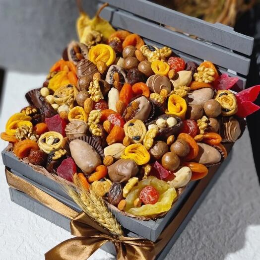 A box with dried fruits and dates in chocolate