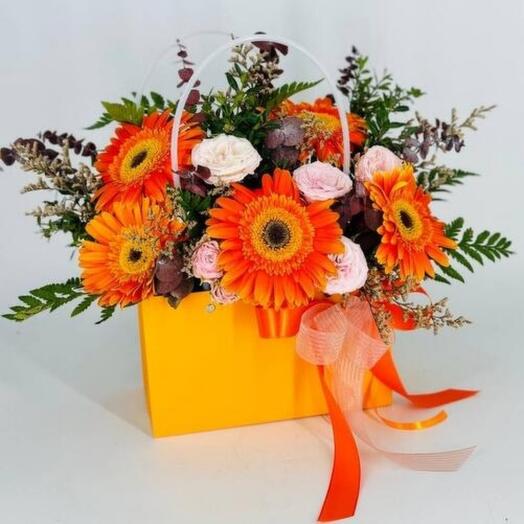 Gerbera flowers with roses in an orange handbag