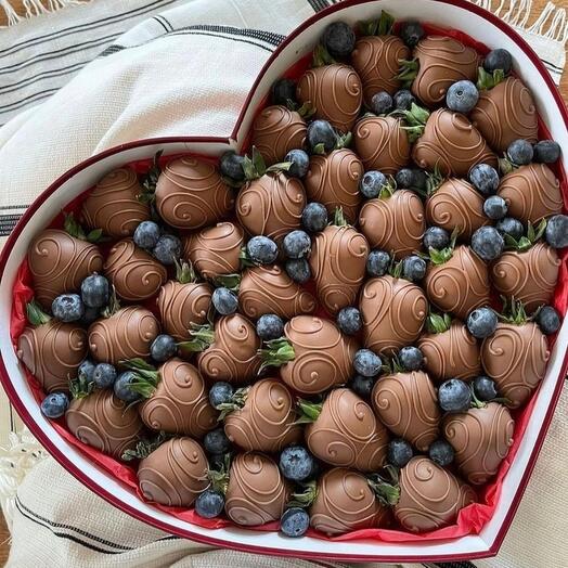 Chocolate-covered strawberries (Babaevsky chocolate) and fresh blueberries in a heart-shaped box