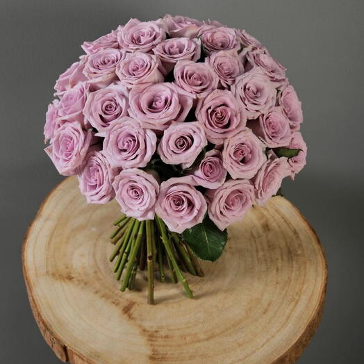 Light Purple rose with brown rope in clear vase