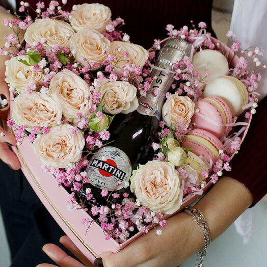 Heart-shaped box with flowers, macarons, and Martini Asti