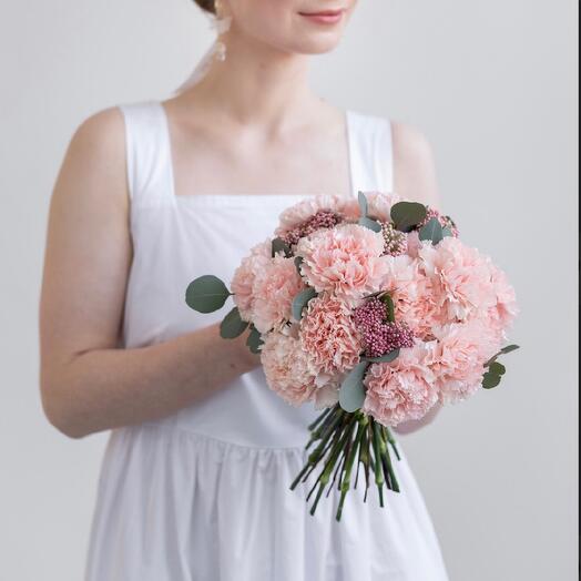 The bride's bouquet of fluffy dianthuses in a classic round shape with ozotamnus and eucalyptus