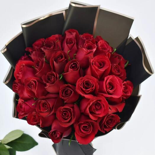 Red roses bouquet with black raping