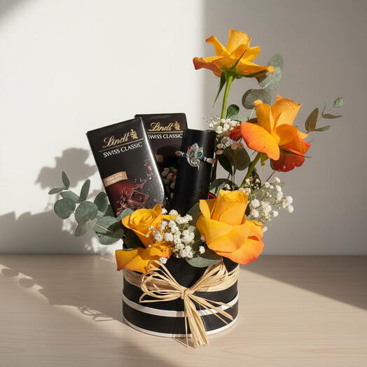 Sunset Glow Gift Box – Orange Roses with Lindt Chocolates in Black Round Box