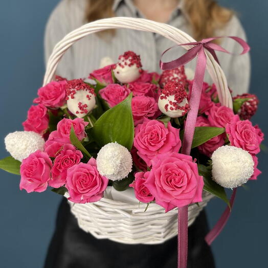 A basket of chocolate-covered strawberries and pink roses