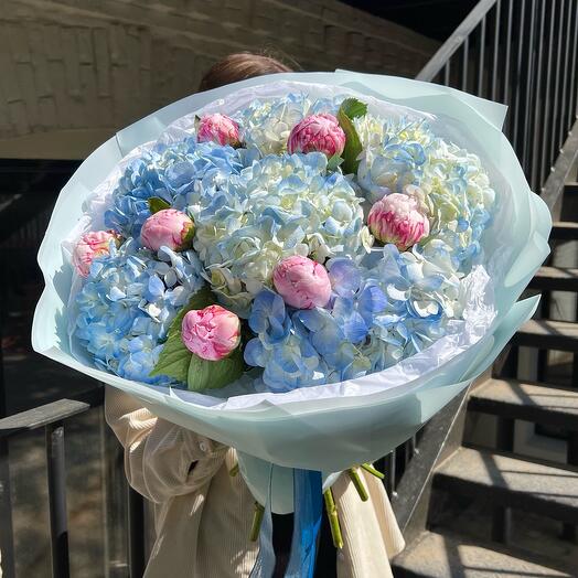 A magnificent bouquet of blue hydrangeas and peonies