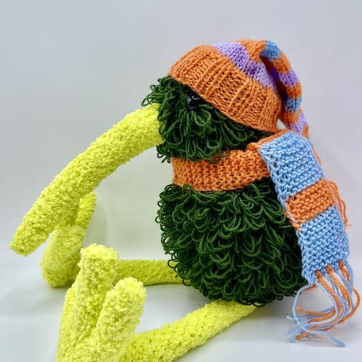 A Kiwi bird in a striped hat. Handmade toy
