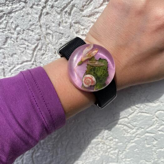 A bracelet with a snowdrop and a snail