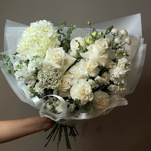 The bouquet is white and delicate with hydrangeas.