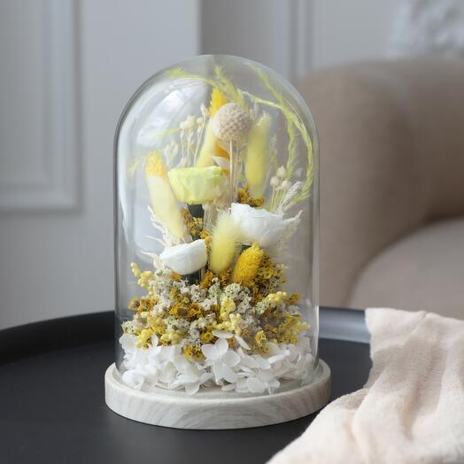 A composition of stabilized flowers and dried flowers in a Solar Ray flask
