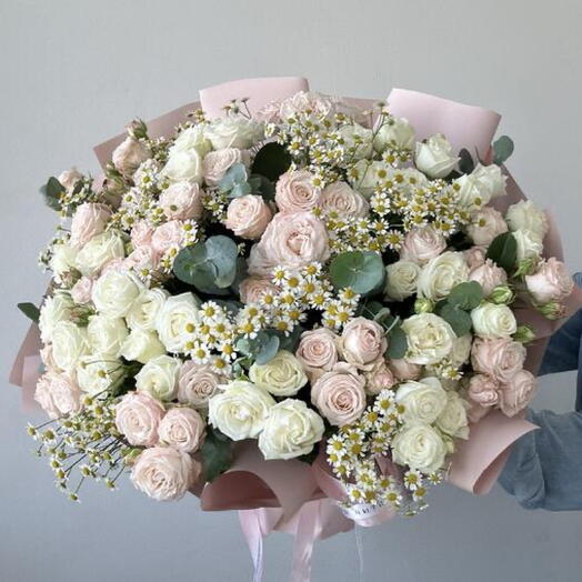 Bouquet of peach and white spray roses with daisies and eucalyptus