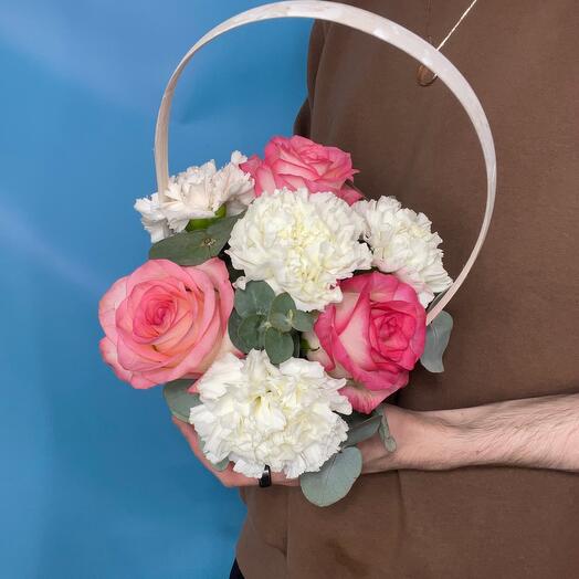 Basket with carnations, roses and eucalyptus