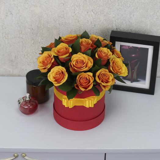 15 red-orange Espana roses with greenery in a hatbox