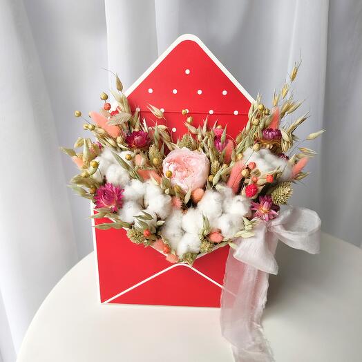 A flower envelope made of dried flowers with a stabilized rose