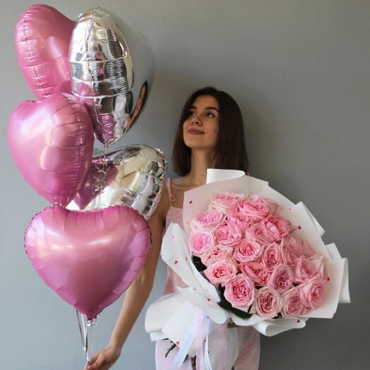 Delicately packed roses with heart shaped foil balloons