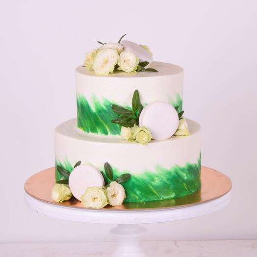 Wedding cake with green strokes, flowers and pasta