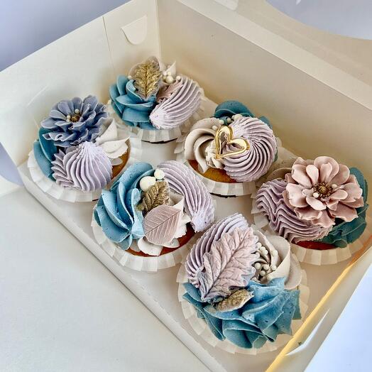 Cupcakes with cream decor and chocolate figures