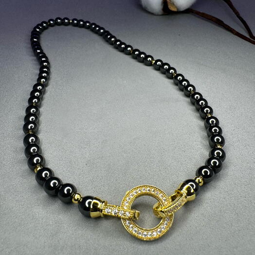 Hematite with 18 K gold toggle clasp