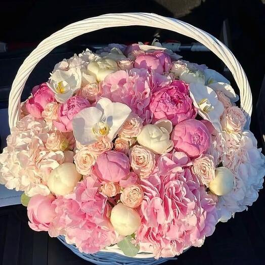 Bouquet of hydrangeas, peonies and orchids in a basket