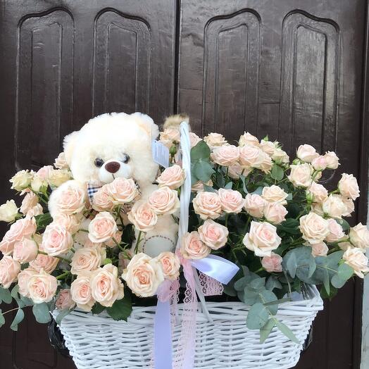 Basket with flowers and a toy