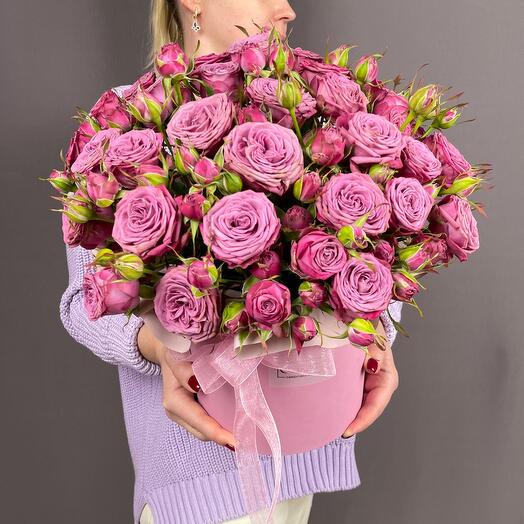 Flowers in a box with a bright purple bush rose