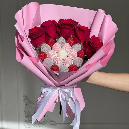 A bouquet of chocolate-covered strawberries with red roses