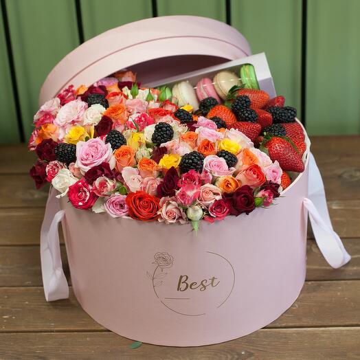A box with flowers, berries and macaroons is a moment of sweet life