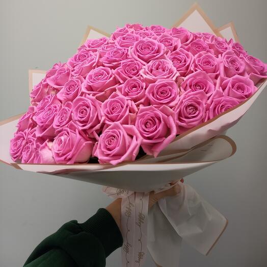 A large bouquet of pink roses in a designer package