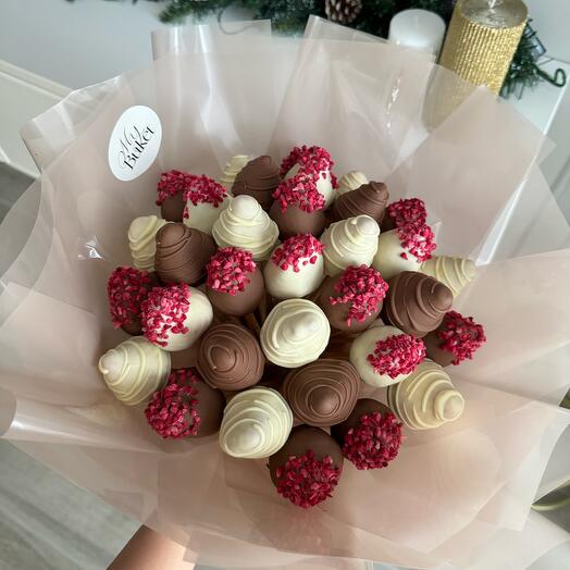 Delicate bouquet of chocolate-covered strawberries with raspberries