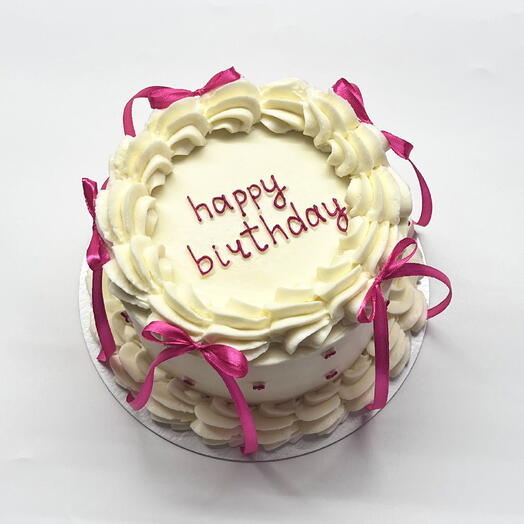 Бисквитный торт 1,1 кг с рюшами, розовыми бантиками и надписью "happy birthday" для девушки