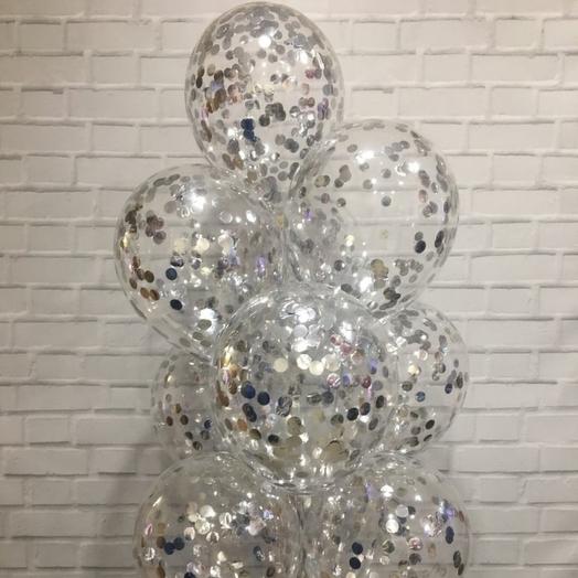 A fountain of balloons with silver confetti