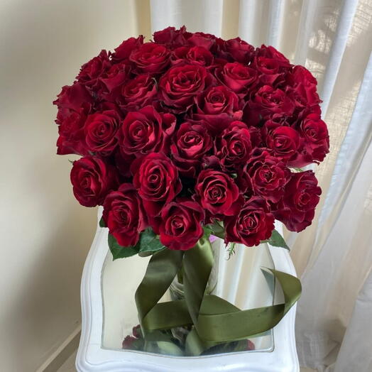 35 red roses in a vase