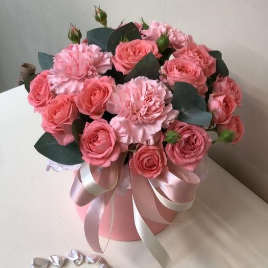 A composition of bushy peony-shaped roses and dianthuses