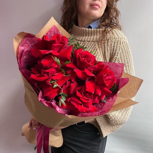 A bouquet of red French roses with greenery