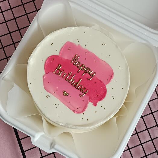 A bento cake with a golden Happy Birthday inscription