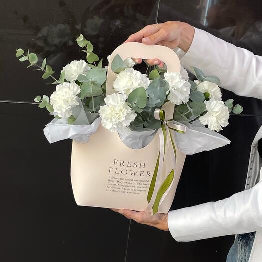 White carnations in a handbag box