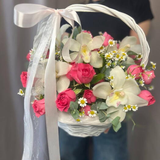 Basket of roses, bush roses, orchid and gypsophila